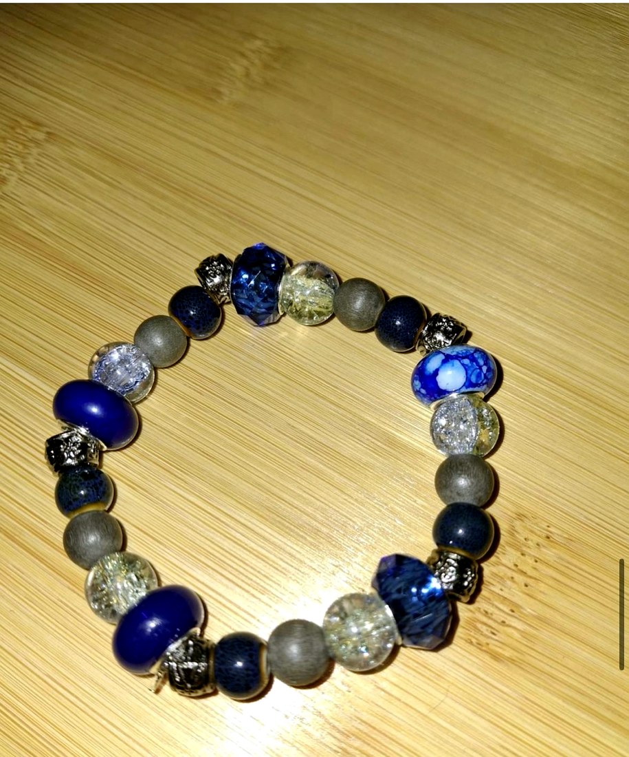 Blue Resin & Glass Bracelet: Blue bracelet with resin, glass, grey wood, porcelain, and metal beads.